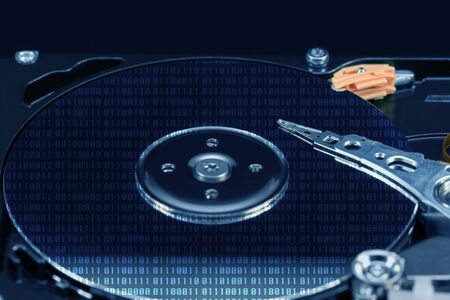 HDD. Close-up of an open computer hard drive. Blue effect with dark background