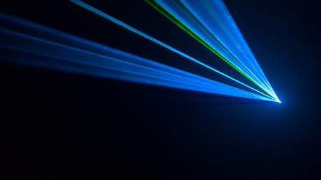 Disco laser light seen from the side. Dark backgroundの写真素材