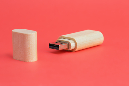 Wood USB flash drive on a red background. Front viewの写真素材