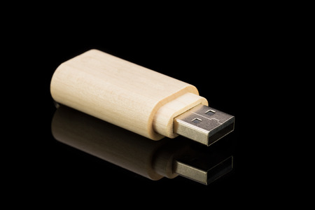 Wood USB flash drive on a black background. Isolated backgroundの写真素材