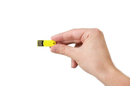 Yellow USB flash memory on hand with isolated white background. Front view