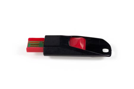 USB memory stick plastic red and black color. White isolated backgroundの写真素材