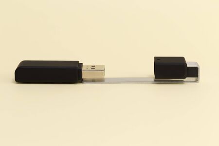 USB memory stick - Black flash drive with the cover on a bright yellow