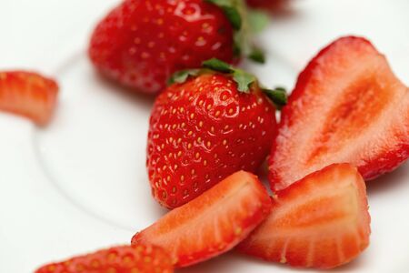 Detail of several strawberries on a plate. Macro viewの写真素材