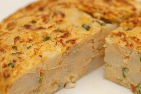 Close-up of a Spanish omelette on an isolated white background. Macro viewの写真素材