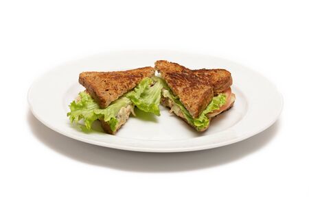 Chicken sandwich and salad cut in half. Isolated white backgroundの写真素材