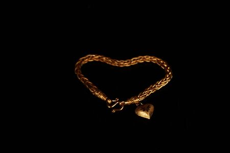 gold necklace on black backgroundの写真素材