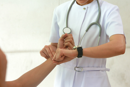 Pulse being taking on a middle aged man's wristの写真素材