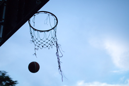 Ball shot into the torn hoopの写真素材