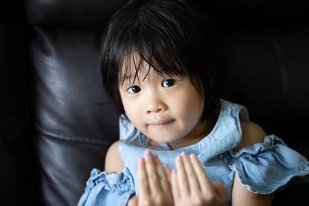 portrait of asian little girl showing innocent and playful emotionの写真素材