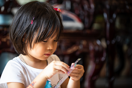 Asian kid playing sticker with intentの写真素材