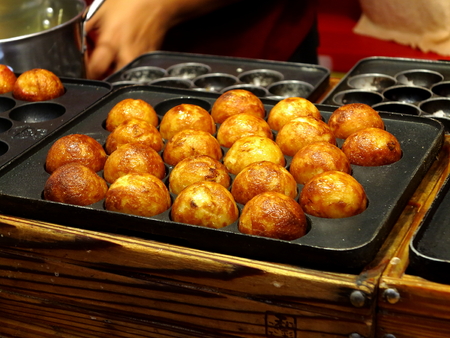 takoyaki on the pan of cast iron with semi-spherical moldsの写真素材