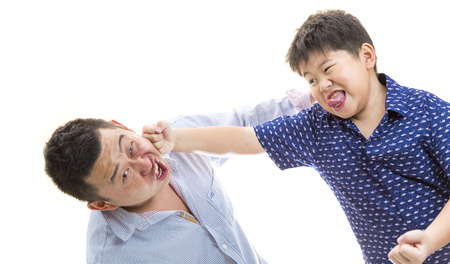 Father and son playing and punching each other on white isolated backgroundの写真素材