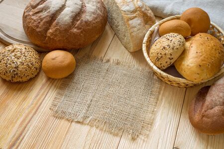 Fresh fragrant bread on the wooden table. place for an inscription