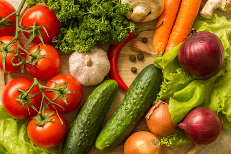 raw vegetables on a round wooden Board. top view.の写真素材
