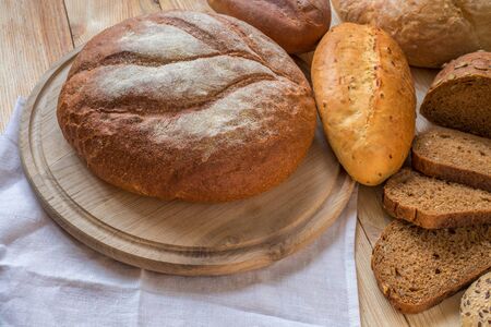 Fresh fragrant bread on a dark wooden table.