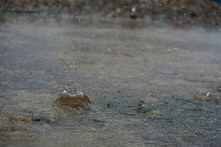 The rain drops falling on the water.の写真素材