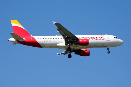 MADRID / SPAIN - MAY 2, 2016: Iberia Express Airbus A320 EC-JSK passenger plane landing at Madrid Barajas Airportのeditorial素材