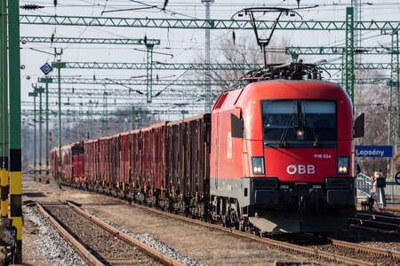 Lepseny, Hungary - February 28, 2021: OEBB Austrian Railways freight freight train with Siemens Taurus 1116 034-0 Locomotive at Lepseny railway train station.のeditorial素材