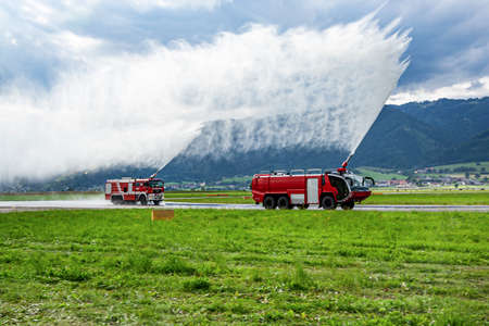 Zeltweg, Austria - June 29, 2013: Fire fighting with water spray. Fire truck and fire engine with...