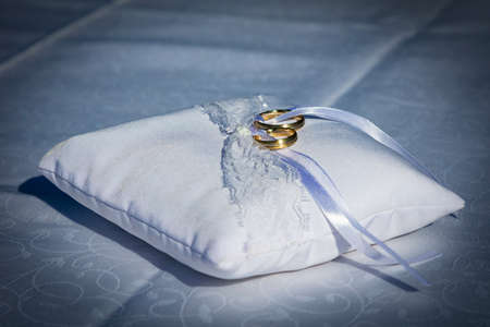 Wedding ring, symbol of love and marriage. Wedding rings creative macro and close up photography. Beautiful golden rings with gems.の写真素材