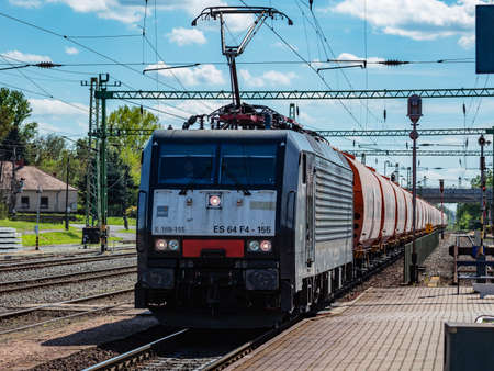 Balatonszentgyorgy, Hungary - May 8, 2021: International train transportation. Cargo freight train wagon at train station. Global transport and shipping.のeditorial素材