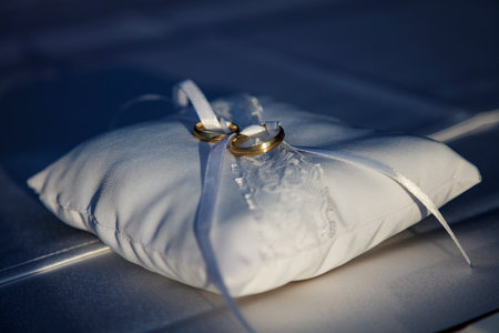 Wedding ring, symbol of love and marriage. Wedding rings creative macro and close up photography. Beautiful golden rings with gems.の写真素材