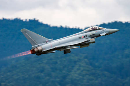 Zeltweg, Austria - June 28, 2013: Military fighter jet plane at air base. Air force flight operation. Aviation and aircraft. Air defense. Military industry. Fly and flying.のeditorial素材