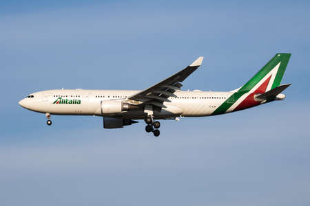 Milan, Italy - April 7, 2017: Alitalia passenger plane at airport. Schedule flight travel. Aviation and aircraft. Air transport. Global international transportation. Fly and flying.のeditorial素材