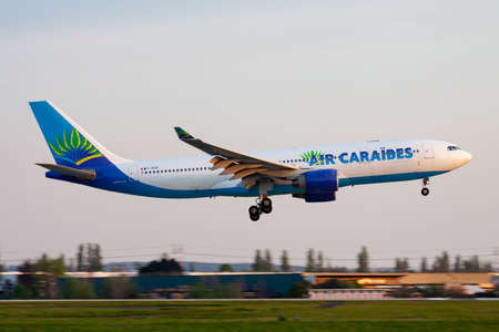 Paris, France - April 18, 2015: Air Caraibes passenger plane at airport. Schedule flight travel. Aviation and aircraft. Air transport. Global international transportation. Fly and flying.のeditorial素材