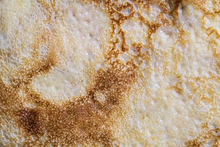 Pancake surface texture and pattern. Close-up of thin hot pancakes in a plate. Traditional rustic...