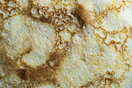 Pancake surface texture and pattern. Close-up of thin hot pancakes in a plate. Traditional rustic food. Graphic resource. Table top view.の写真素材