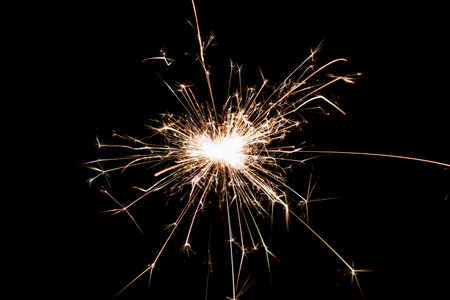 Burning sparkler isolated on black background. Fireworks theme. Light effect and texture. Christmas and new year decoration.の写真素材