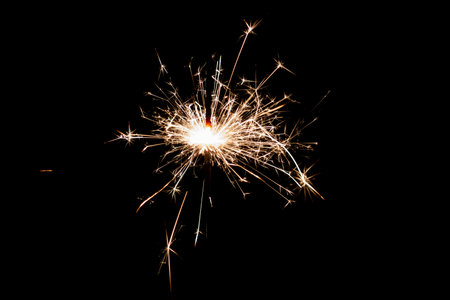 Burning sparkler isolated on black background. Fireworks theme. Light effect and texture. Christmas and new year decoration.の写真素材