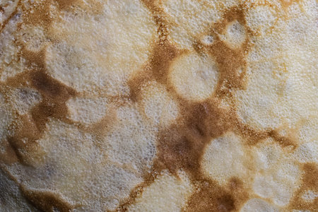 Pancake surface texture and pattern. Close-up of thin hot pancakes in a plate. Traditional rustic...