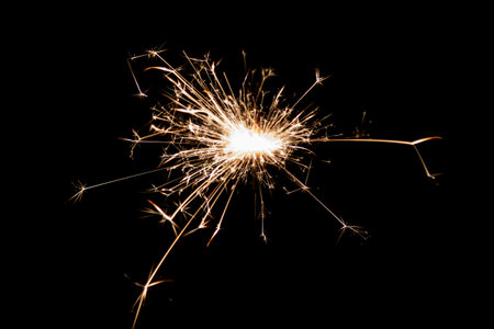 Burning sparkler isolated on black background. Fireworks theme. Light effect and texture. Christmas and new year decoration.の写真素材
