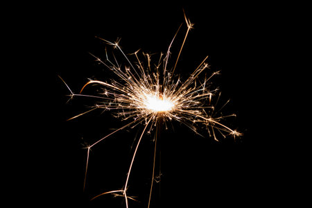 Burning sparkler isolated on black background. Fireworks theme. Light effect and texture. Christmas and new year decoration.の写真素材