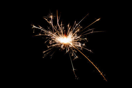 Burning sparkler isolated on black background. Fireworks theme. Light effect and texture. Christmas and new year decoration.の写真素材