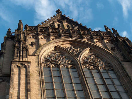 Catholic, christian church, monastery, temple, palace, against a blue sky, stylish window, ornamented facade, european architectureの写真素材