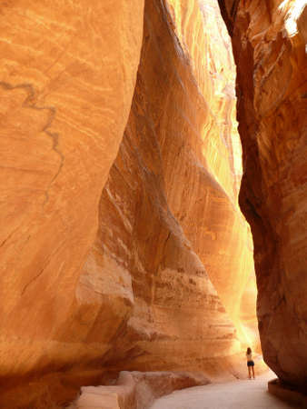 A woman wandering along the Siq gorge in Petra, Jordanの写真素材
