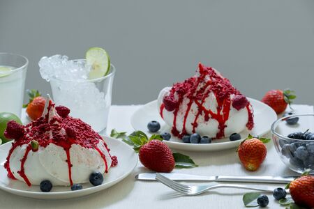 Dessert strawberries and lime drinks on dinning tableの写真素材