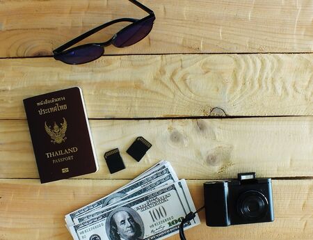 Travelers prepare before traveling abroad. Prepare passports, banknotes, wrist watches, compact...
