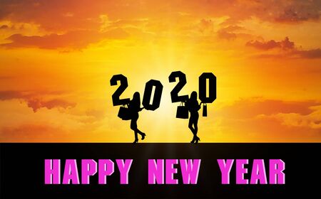 Happy New Year 2020 Silhouette. Two girls holding a shopping bag standing holding numbers 2020 Sunset timeの写真素材