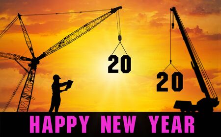 Happy New Year 2020.A female engineer inspects the move and arranges the 2020 figures at the top of...