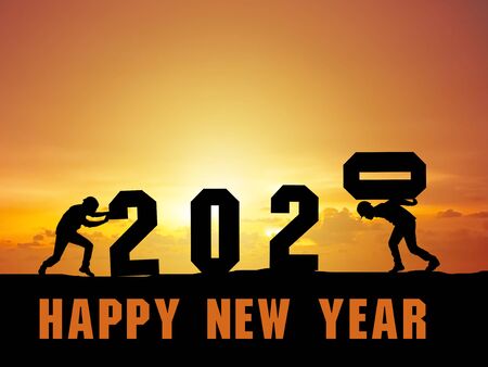Happy new year 2020 2 male workers are working to install the letters 2020
