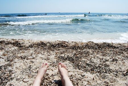 Martigues: Beautiful beach with the sea on a sunny summer day with feet that tanの写真素材