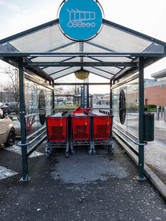 Shopping trolleys outside the supermarket Auchan