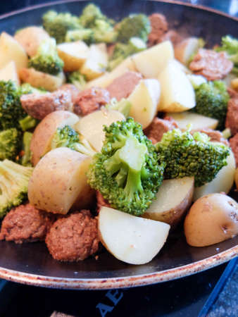 Yummy vegetarian dish in the pan: potatoes, veggie meatball and broccoliの写真素材