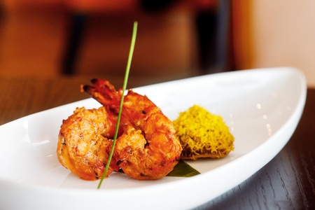 King Prawn Tikka accompanied with a saffron rice cake is another tasty delight of Indian cuisineの写真素材
