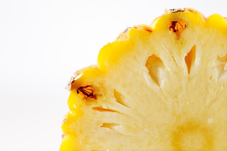 A slice of a fresh organic pineapple on a white backgroundの写真素材